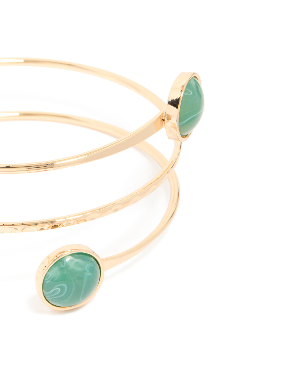 Featuring a gold statement arm cuff with teal stones close up view