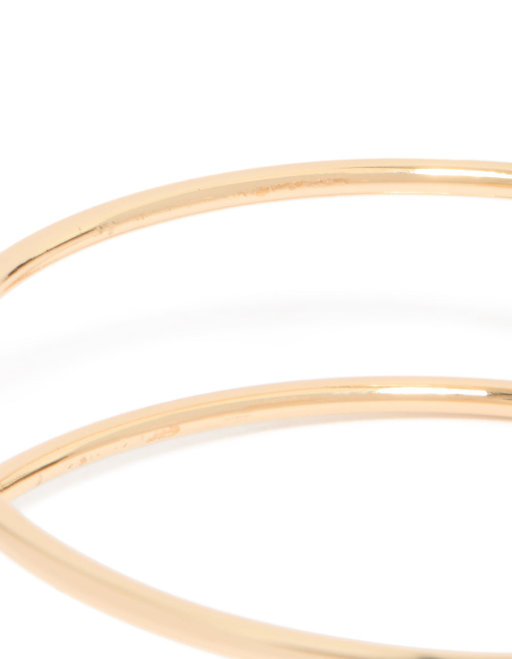 Featuring a gold statement arm cuff with teal stones close up view