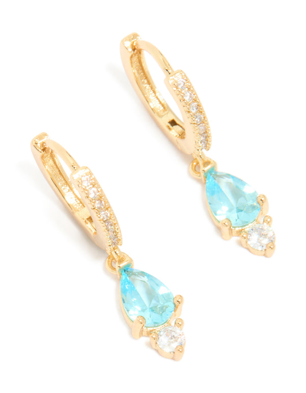 Featuring gold plated blue cubic zirconia huggie earrings close up view
