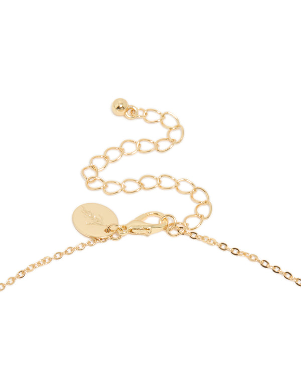 Highlighting a charm Y-necklace in gold plated material blue cubic zirconia stones clasp detail view