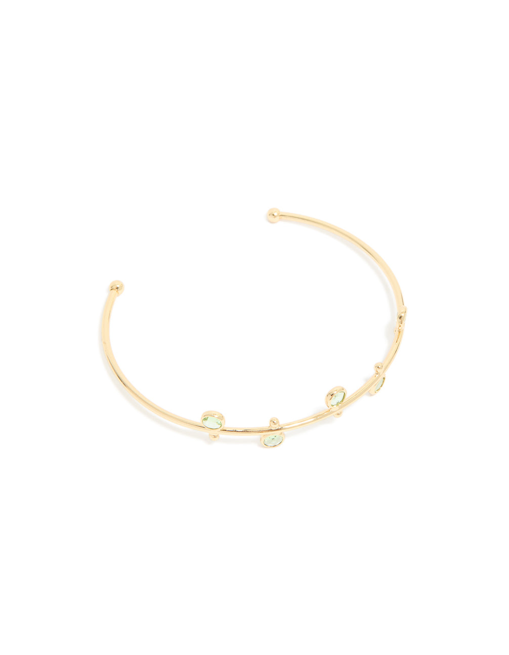 Discover this gold plated and green cubic zirconia wrist cuff in a statement style front view