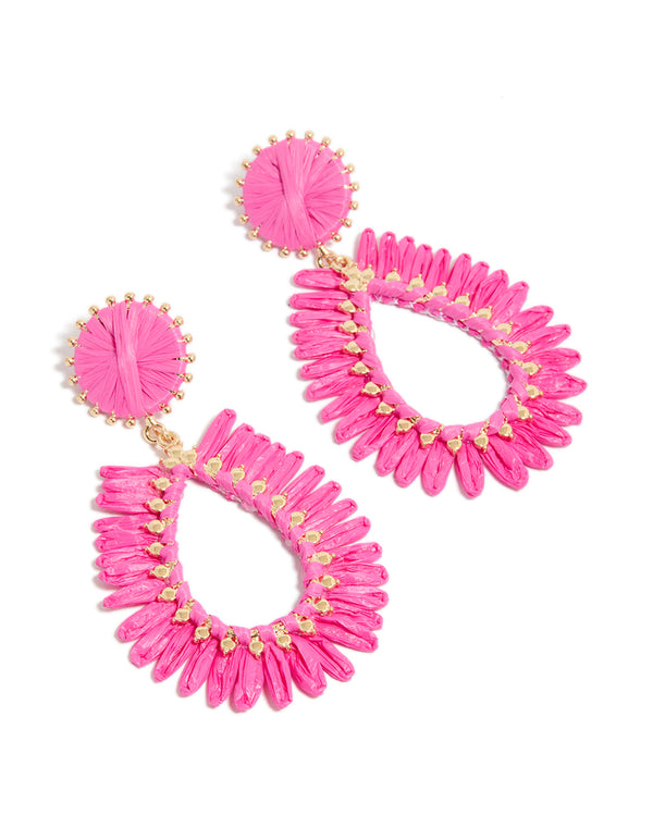 Showcasing statement gold hot pink raffia oval drop earrings front view