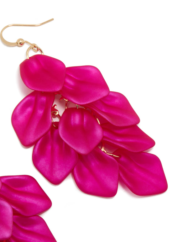 Highlighting fuchsia pink coated metal petal drop statement earrings with gold hook detail view