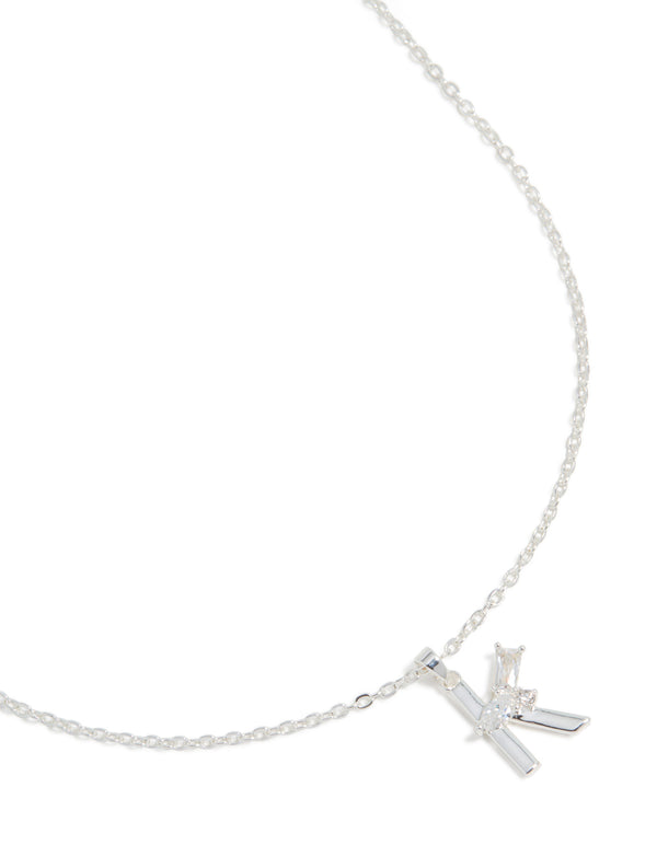 Showcasing a dainty initial letter K pendant necklace in silver-plated metal featuring cubic zirconia stones, close up view