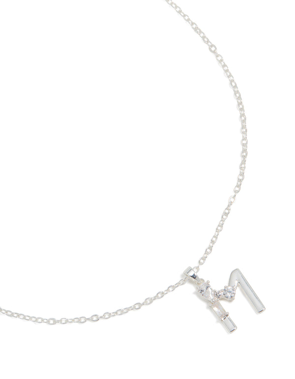 Showcasing a thin cubic zirconia letter M necklace with an initial pendant, crafted from silver plated, close up view
