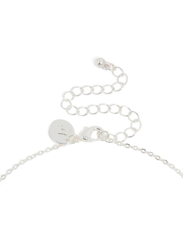 Featuring thin cubic zirconia letter M necklace with an initial pendant and silver plated pendant clasp detail view
