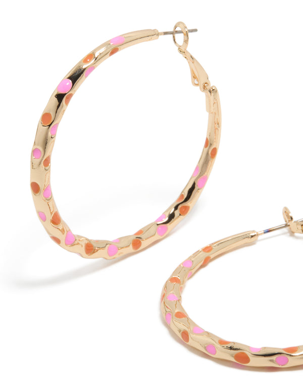 Crafted with large statement hoop earrings in enamel dotted design featuring pink and orange on thin closure close up view