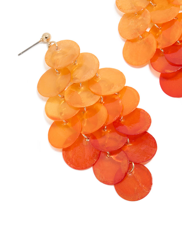 Featuring orange genuine shell layered discs in waterfall drop design with statement coral and peachpuff gradient close up view