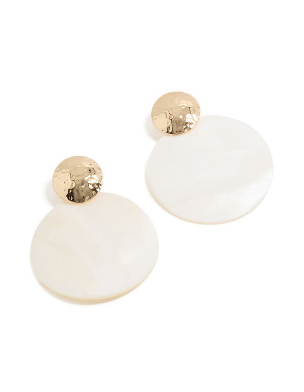 Showcasing statement ocean-inspired drop earrings with hammered gold stud and white genuine shell disc in front view
