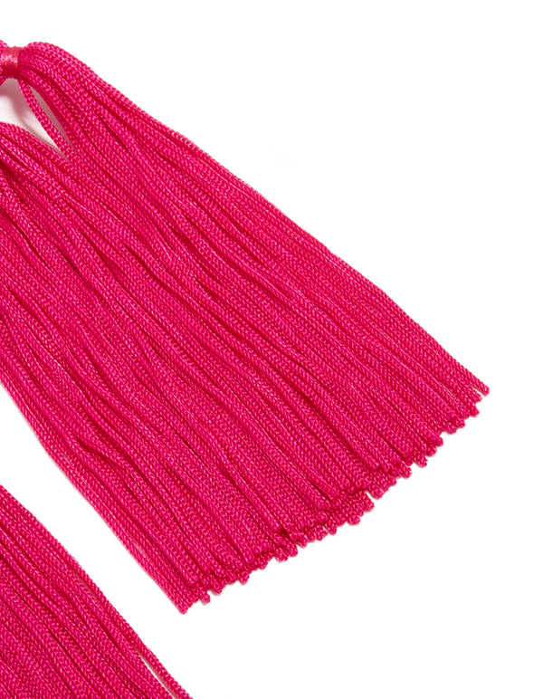Capturing statement hot pink fabric tassel drop earrings with beads in intricate close up view