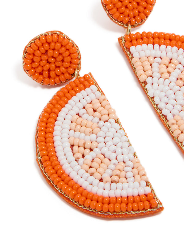 Featuring beads and fruit design in orange white and peachpuff statement drop earrings close up view