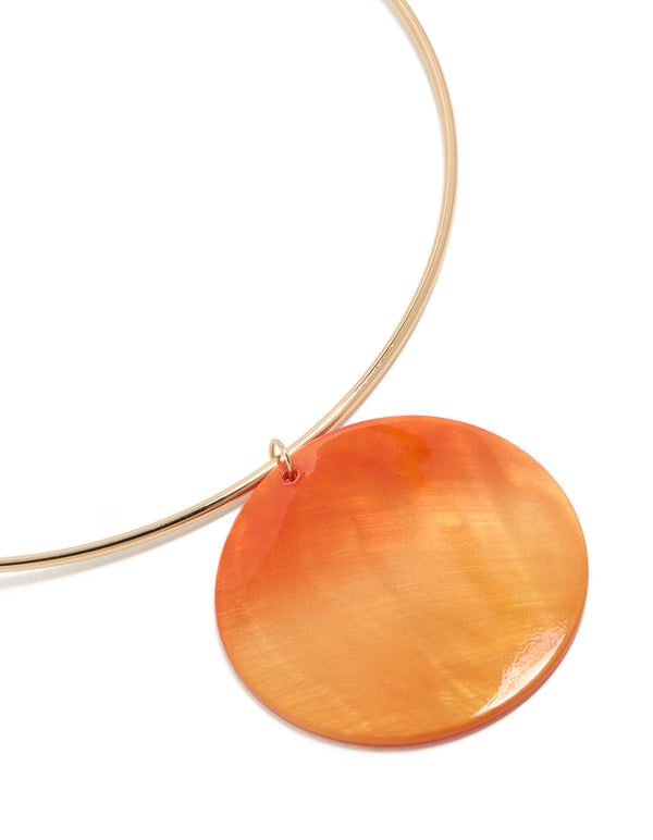 Featuring a gold orange genuine shell disc torque necklace in a chunky style close up view