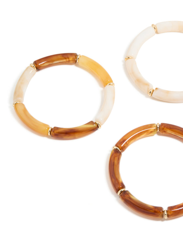 Crafted with bead detailing, these gold brown and orange acrylic stretch bracelets offer a close up view