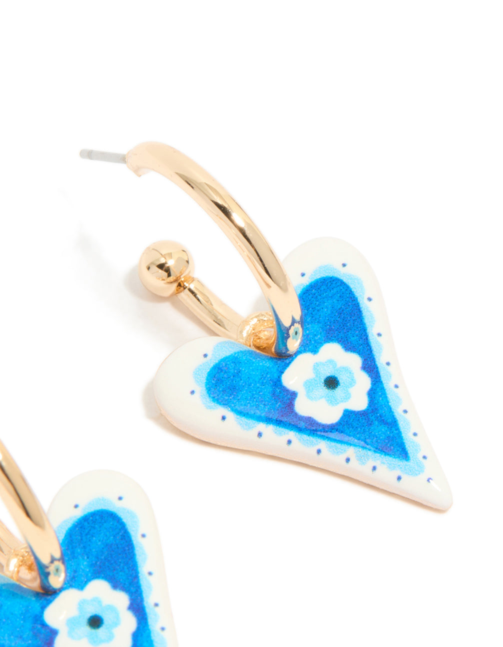 Highlighting gold blue heart huggie earrings with a flower inside featuring post detail view