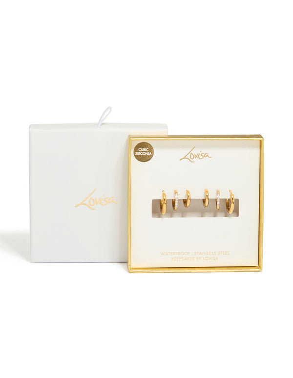 Displaying waterproof gold plated stainless steel cubic zirconia essential stacking huggie earrings in a 3-pack with crystal accents and closure front view
