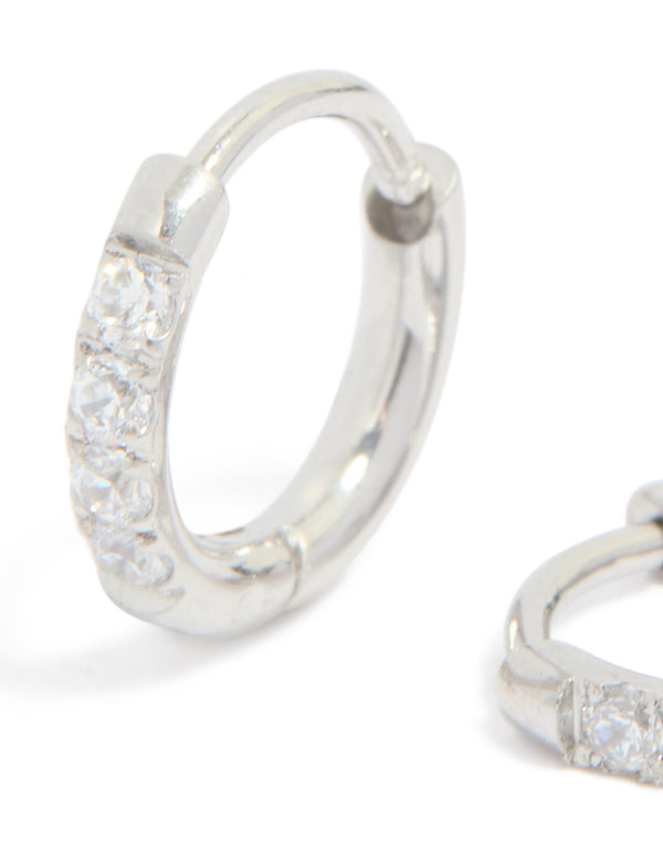 Featuring kids surgical steel sleeper earrings with cubic zirconia in silver close up view