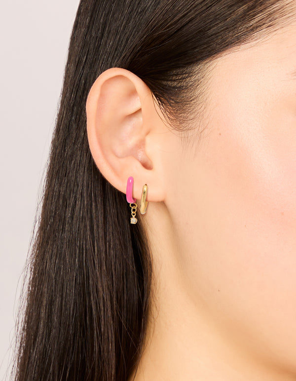 Featuring waterproof gold plated stainless steel pink enamel and cubic zirconia huggie earrings 2-pack on ear view