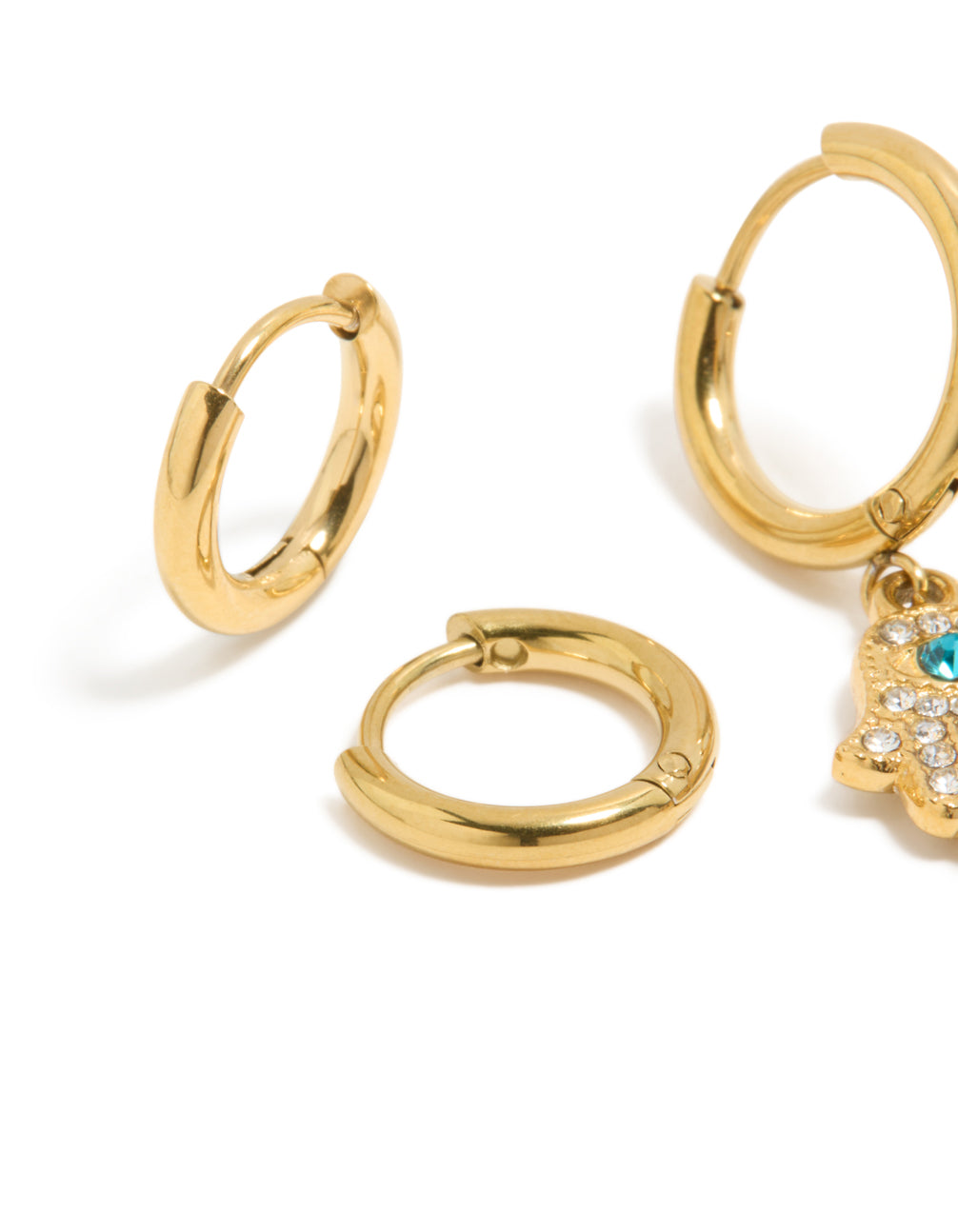 Designed with waterproof gold plated stainless steel evil eye hamsa hand diamante huggie earrings in a 2-pack with turquoise and clear accents close up view