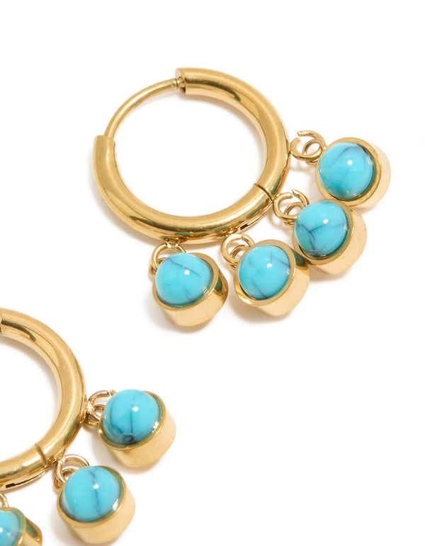 Featuring chunky huggie earrings with charm details, crafted from waterproof stainless steel and turquoise in gold plating close up view