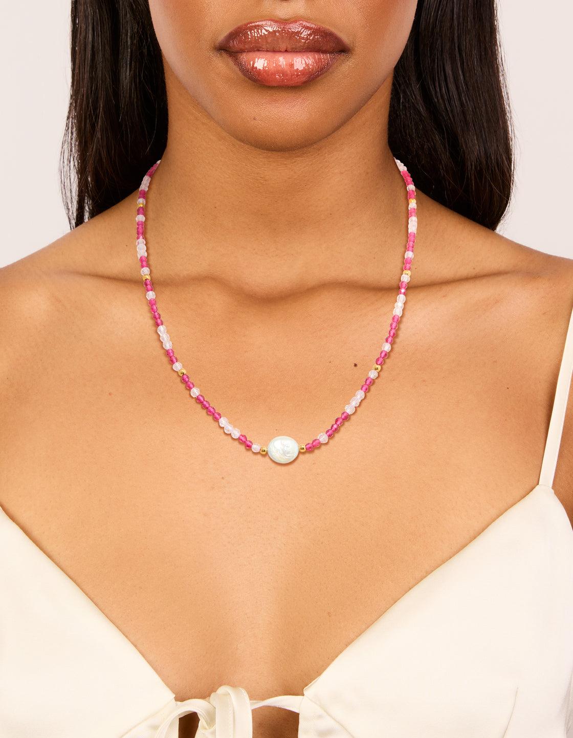Designed with waterproof beaded necklace featuring pearl crafted from gold plated stainless steel in pink on neck view