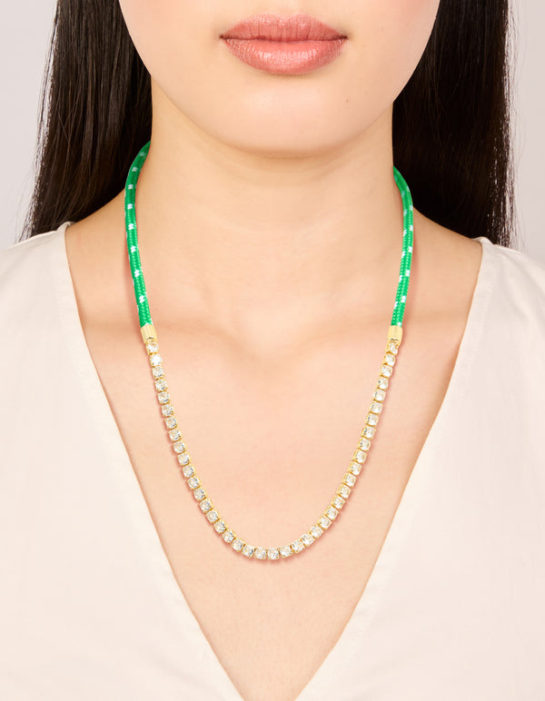 Elegantly styled waterproof half tennis half green cord necklace in stainless steel and gold plated with clear accents on neck view