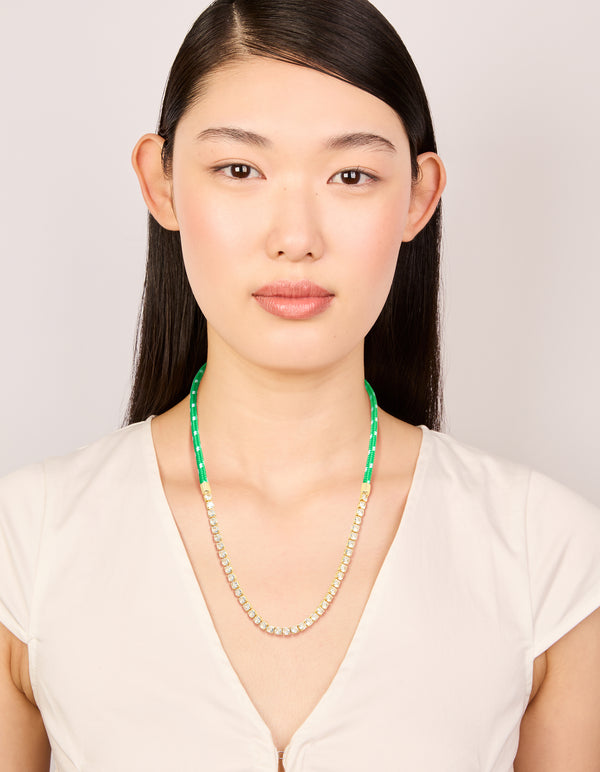 Beautifully presented waterproof half tennis half green cord necklace made from stainless steel and gold plated in clear on model view