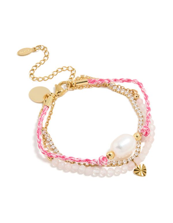 Showcasing waterproof stainless steel tennis bracelet featuring heart ,beads with cubic zirconia, cord, and freshwater pearl accents in pink, white, and gold plated finish front view