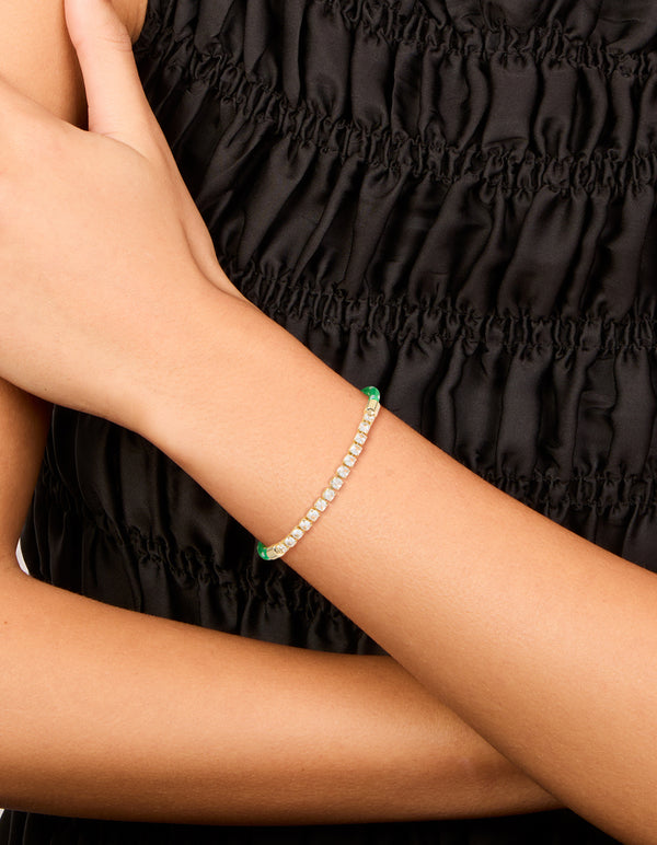 Designed with waterproof gold plated stainless steel half tennis and half vibrant green cord bracelet featuring white accents and statement style on wrist view