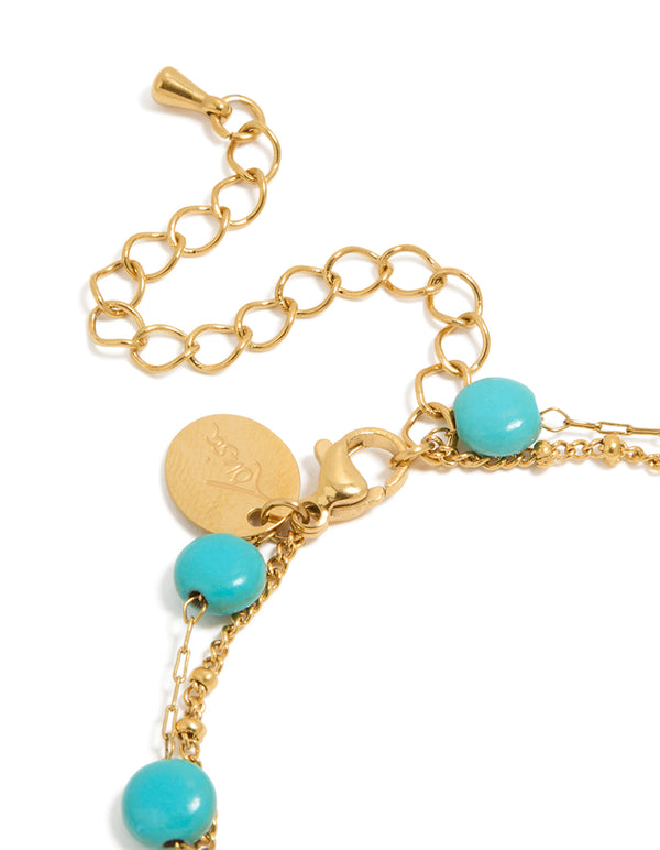 Highlighting waterproof beaded stainless steel disc turquoise semi precious stone and green accents bracelet in gold plated finish closure detail view