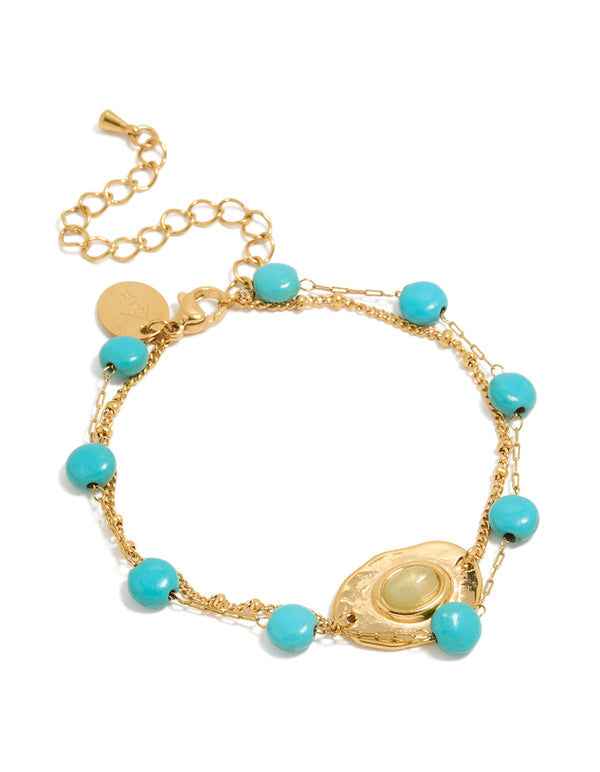 Showcasing waterproof beaded stainless steel disc turquoise semi precious stone and green accents bracelet in gold plated finish front view