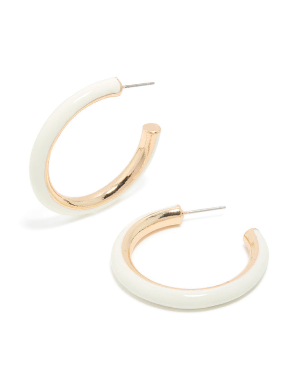 Showcasing statement hoop earrings in gold with ivory acrylic finish front view