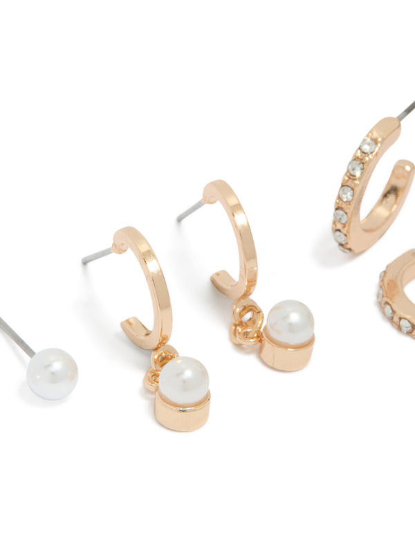 Featuring dainty gold pearl and diamante huggie and stud earrings in a 3-pack close up view