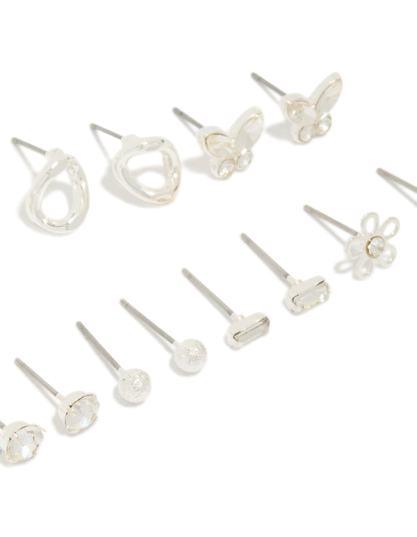 Featuring silver and diamante teardrop earrings 7-pack featuring butterfly, ball, and floral accents with clear stone details and stud closure close up view
