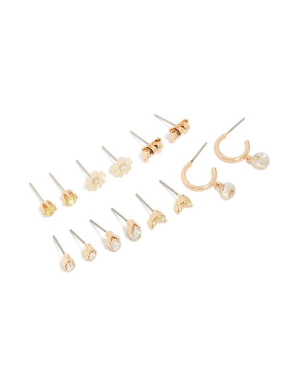 Showcasing a gold flower and bow earrings 7-pack in stud and hoop closures front view