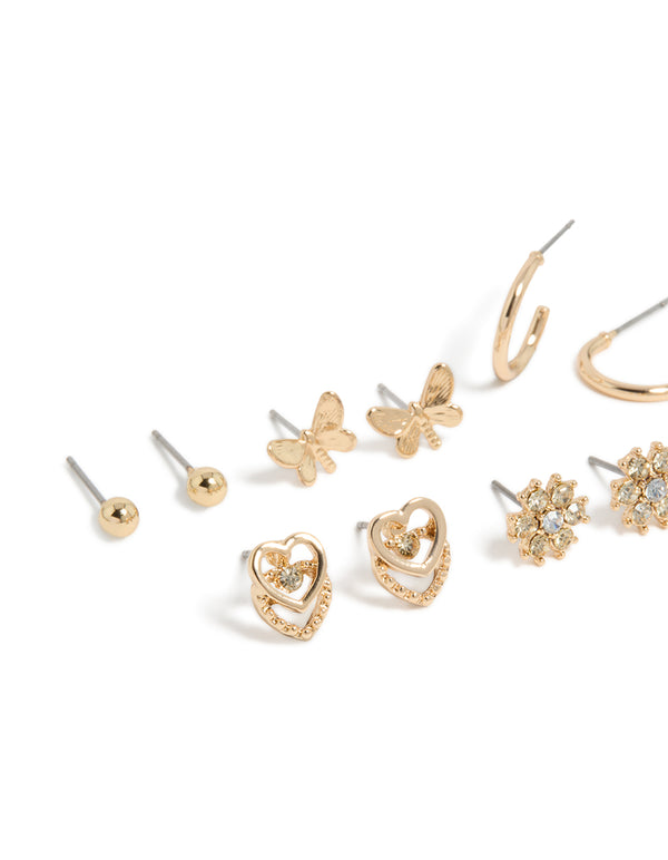 Showcasing gold diamante flower ,heart and butterfly design stud earrings 7-pack and stud closure close up view