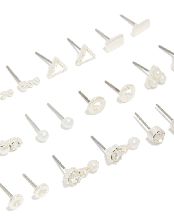 Explore this 12-pack of stud earrings with floral, triangle and pearl accents in silver and white close up view