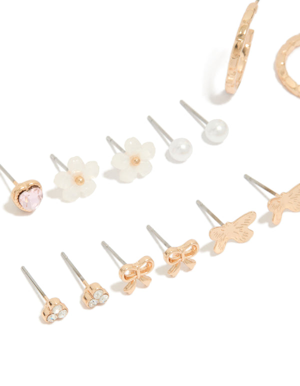 Crafted gold earrings 8-pack featuring bow, heart, pearl and butterfly details with stud and hoop closure in ivory, pink, and silver accents close up view