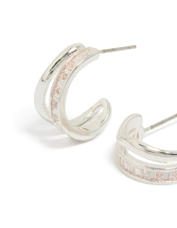 Featuring silver plated cubic zirconia illusion baguette hoop earrings with statement design close up view