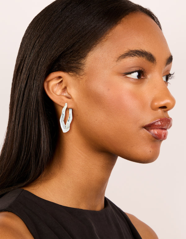 Crafted from silver plated material, these large hoop on model view