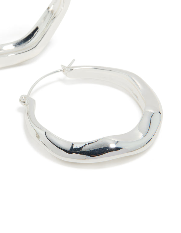 These silver plated large hoop earrings showcase polished finish close up view