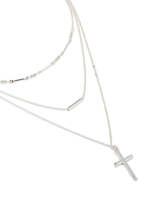 Discover this silver plated bar and cross layered necklace featuring balls, beads with dainty styling close up view