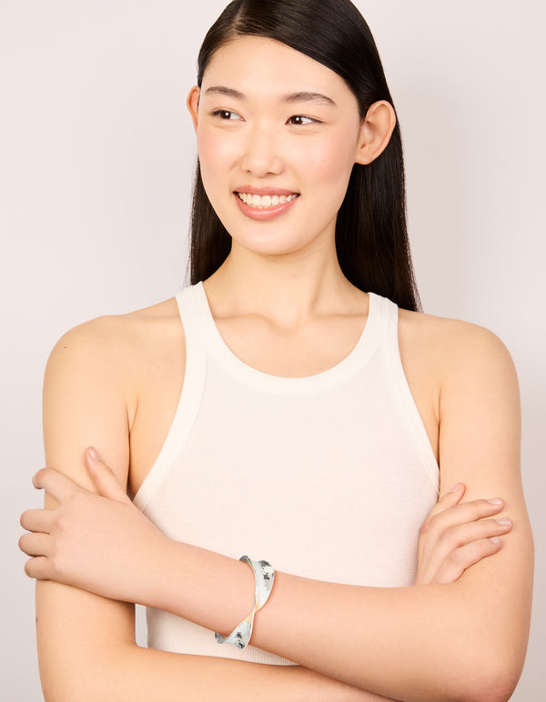 Crafted from silver plated hammered twist hinged bangle on model view