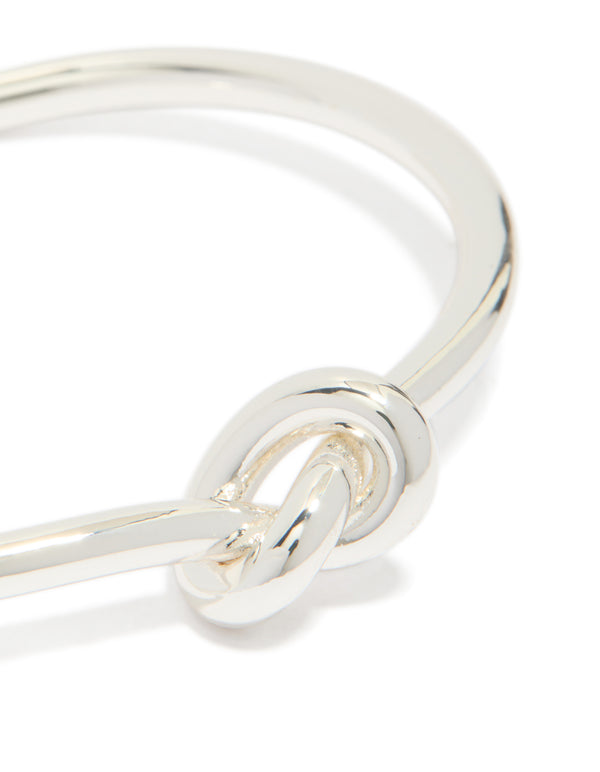 Featuring silver plated statement knotted bangle cuff bracelet with intricate knot detail close up view