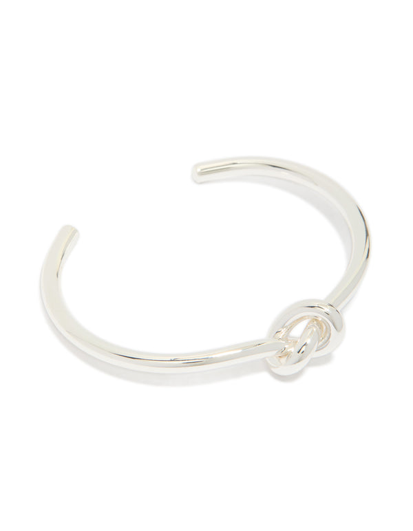 Showcasing a silver plated knotted wrist cuff featuring statement bangle design front view