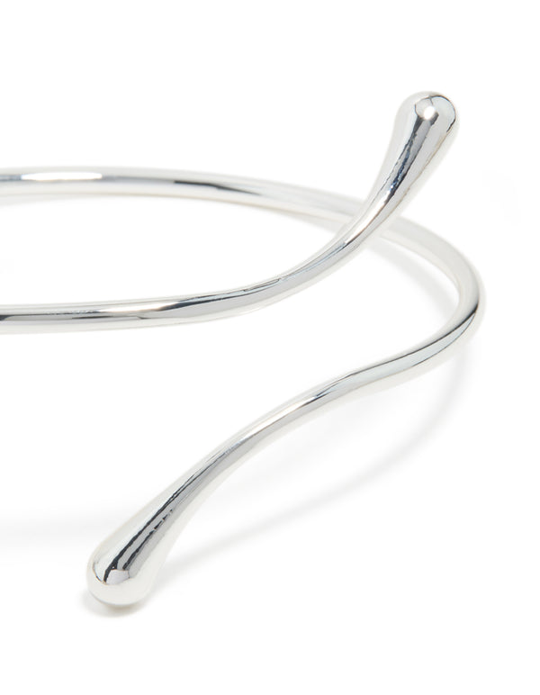 Featuring a molten drop arm cuff in silver plated metal with statement design close up view