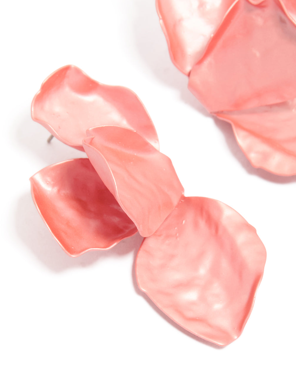 Elegant coated metal drop earrings with floral petal design in light pink and coral close up view