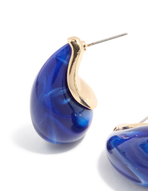Elegant gold pear drop earrings in blue stone design close up view