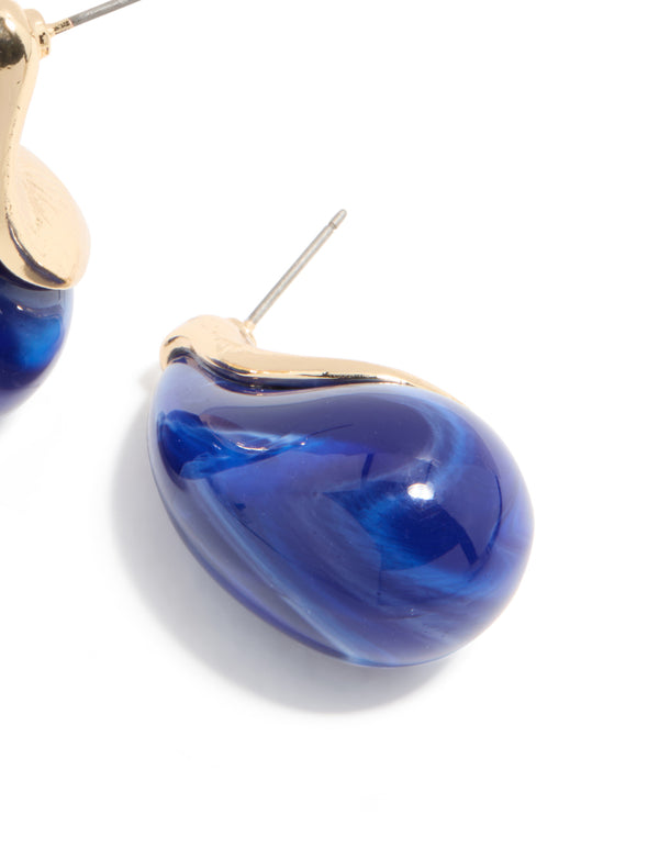 Crafted from gold, these pear drop earrings feature blue stone elements post detail view