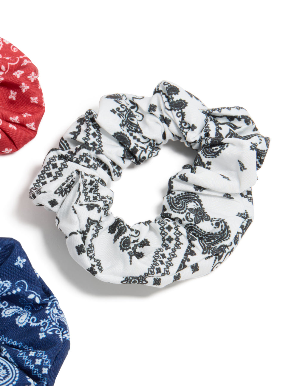 Featuring paisley print fabric scrunchies in a 3-pack with navy, white, coral, and light sky blue detail view