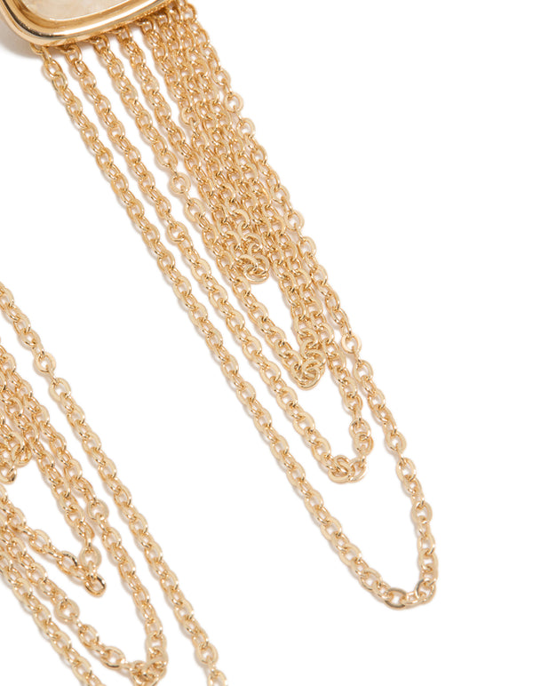 Showcasing statement gold white stone and layered chain drop earrings close up view